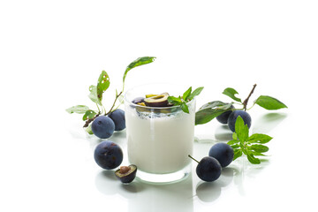 Obraz na płótnie Canvas sweet homemade yogurt with fresh plum slices in a glass