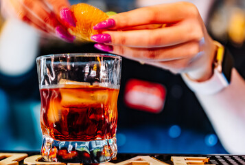 woman hand bartender making negroni cocktail in bar