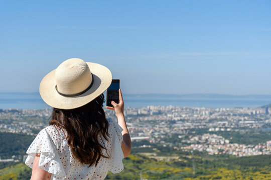 Rear View Of Woman Taking Photos Of Cityscape Of Split In Croatia