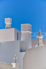 Traditional chimney on the roof of a houses in Olhao, Faro district, Algarve, Portugal