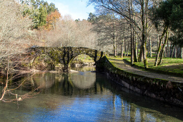 Fototapeta na wymiar Landscape with a river and a stone bridge. River beach of Maceira, Galicia, Spain.