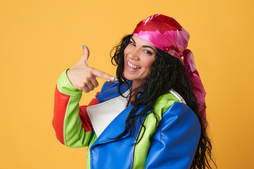 a woman wearing a pink headscarf with a gesture of approval optimistic woman