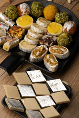Group of Indian assorted sweets or mithai with diya

