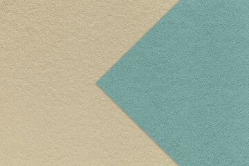 Fototapeta na wymiar Texture of old craft beige paper background, half two colors with light blue arrow. Vintage kraft sand cardboard.