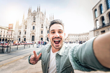 Happy tourist taking selfie in front of Duomo cathedral in Milan, Italy - Holidays and traveling...