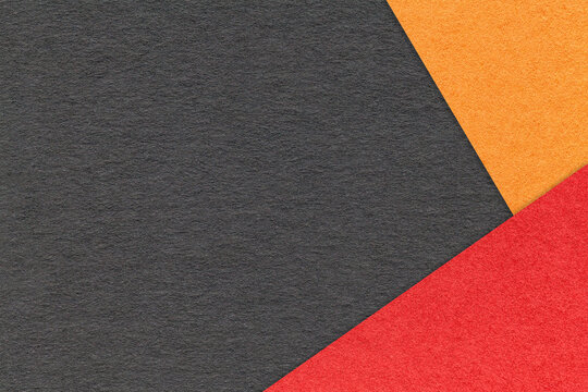 Craft black color paper background with red and orange border. Vintage gray cardboard. Presentation template