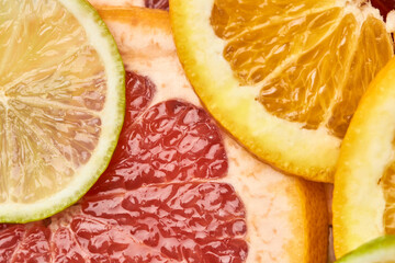 Top view of sliced ​​citrus on a tray. Orange, grapefruit, lemon and lime showcasing healthy food in a flat lay. Natural beauty, medical concept of cliced fruits.