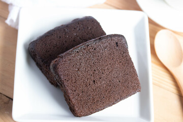 Chocolate cake with coffee in a white plate