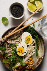 Top down view of Japanese soba noodle ramen soup on white background