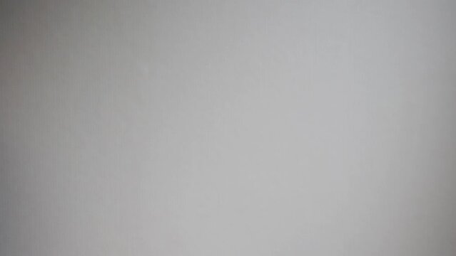 Shot of few bank notes falling across the shot in a white environment.