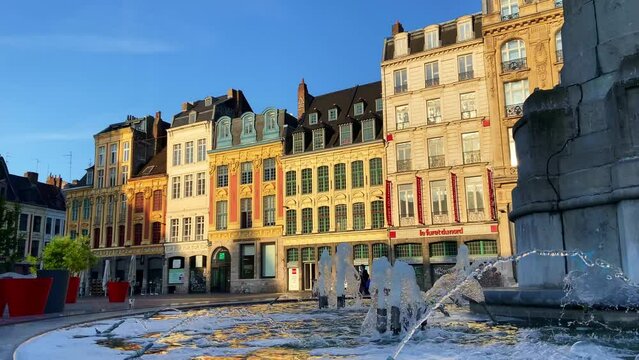 Water Fountain Of The Colonne de la Deesse At Grand Place With Striking Architectures In The Background In Lille, France. - wide
