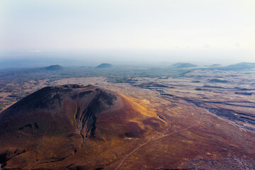 Aerial panorama of the mountain volcano valley with breakthrough hills
