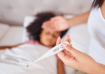 Thermometer, mother and girl in bed, sick with fever and covid risk in a bedroom, measuring on...