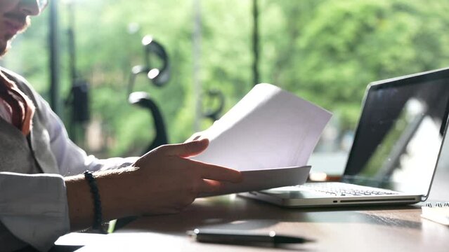 Business man checking documents in office closeup. Man hand analyze report. Unrecognizable financial manager lawyer study legal papers.