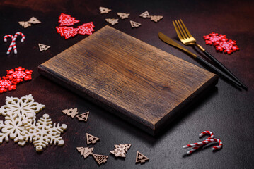 Christmas decoration elements as well as gingerbread on a brown concrete background