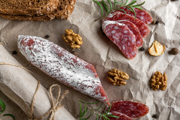 Sausage and bread and spices on the table. Tasty food.