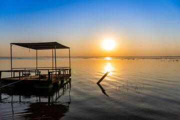 Obraz premium sunset by the river with boat