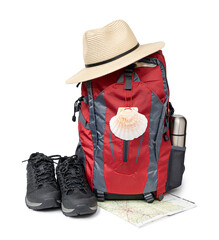 Pilgrim backpack with scallop symbol, hat and boots isolated on white background. Camino de Santiago Pilgrimage equipment - obrazy, fototapety, plakaty