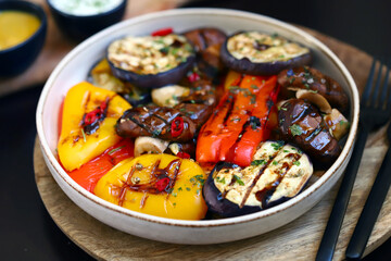 Grilled vegetables on a plate. Healthy food. Appetizing grilled peppers, eggplant, mushrooms.