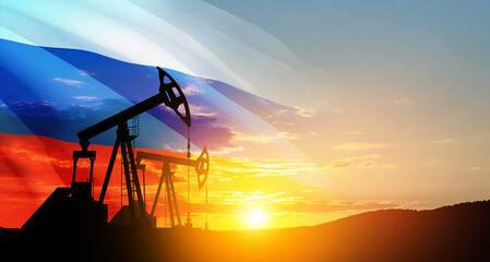 Fototapeta premium The change in oil prices caused by the war. Oil prices are rising because of the global crisis. Oil drilling derricks at desert oilfield with Russia flag. Crude oil production from the ground.