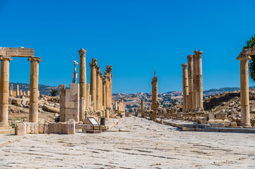 A view down a colonnaded street in the ancient Roman settlement of Gerasa in Jerash, Jordan in summertime