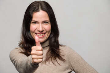 happy woman showing thumbs-up gesture with a big smile