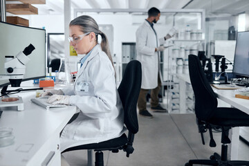 Laboratory woman, microscope or computer typing in cancer research, medical healthcare innovation...
