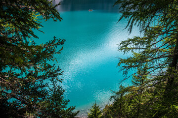 Turquoise lake with canoe