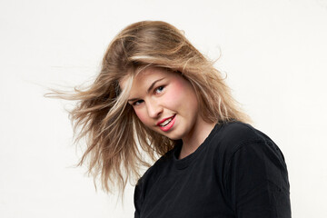 Naklejka premium close up of young woman with wind in hair