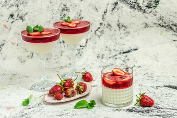 Sweet strawberry mousse with organic yoghurt panna cotta, with strawberry and mint on a light background. Summer yogurt dessert. space for text