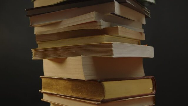 Pile of books spinning with the camera tilting up