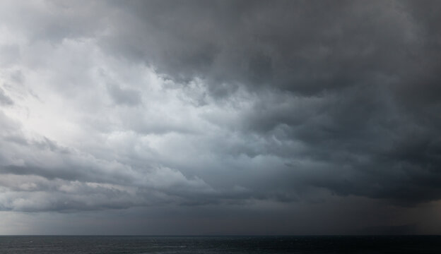 Dramatic dark stormy sky over sea water, natural photo