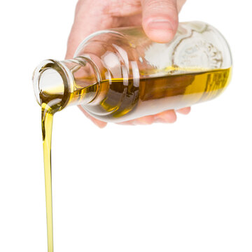 Hand Holding Bottle With Oil Pouring, PNG Isolated On Transparent Background  