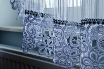 Close up of curtain part. curtain in window frame, interior detail. Beautiful transparent white curtains in an apartment