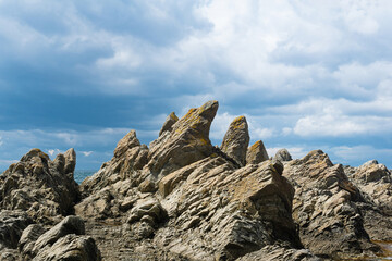 sharp jagged basalt rocks on the sea coast, Cape Stolbchaty on Kunashir Island