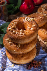 Traditional tasty ready to eat apple cider donuts. Homemade baked apple cinnamon donuts with apple pie crumble and spices, served on wooden table copy space