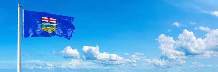 Foto op Plexiglas Alberta - state of Canada, flag waving on a blue sky in beautiful clouds - Horizontal banner  © Lulla