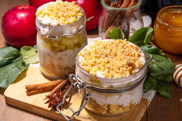 Apple pie in jar, apple layered breakfast parfait dessert, with tart crumble and spices, No Bake cheesecake in a portioned jars