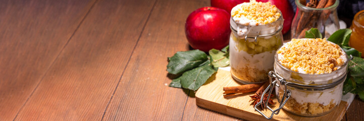 Apple pie in jar, apple layered breakfast parfait dessert, with tart crumble and spices, No Bake cheesecake in a portioned jars