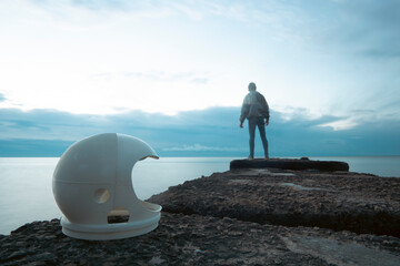 Astronaut with 3D printed helmet pointing towards a jellyfish. Concept: Exploring extraterrestrial worlds alone