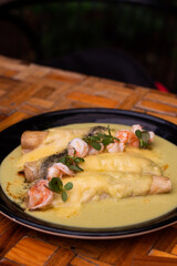 Meal with tortilla, cheese, shrimps, spinach, and mexican sauce