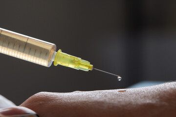 Doctor doing stem cell therapy on a patient's elbow after the injury. Treating knee pain with...