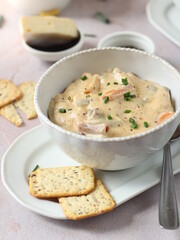 Camembert white sauce with Colored pasta, fresh chives and crackers