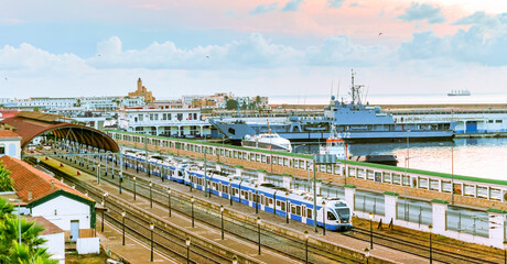 Algiers train station and port with a train parked and a coastguard Algerian Naval Forces vessel...