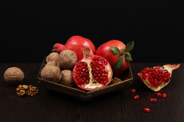 Red pomegranate on a black background. Shallow depth of field