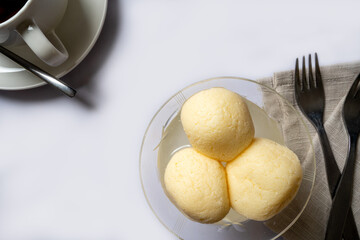 Indian dessert in syrup rasgulla, popular in the Bengal region of India, served in a glass dish. Also knoiwn as Rasagola, Rosogola or Rosogolla