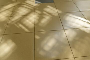 Sunlight on the tile, the rays of the sun on the floor. Selective focus