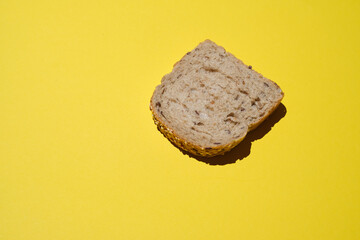 Bread. Sliced  bread's with seeds on a yellow background. Healthy Diet. sliced organic bread. Top view. Artisan bread with seeds. Rustic sourdough bread.