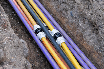 underground electric cable infrastructure installation. Construction site with A lot of communication Cables protected in tubes. electric and high-speed Internet Network cables are buried underground 