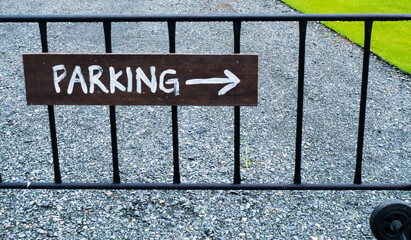 Parking sign wooden at parking lot outdoor.
